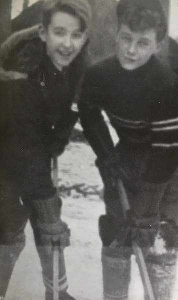 Robert Fulford and another boy, with hockey sticks